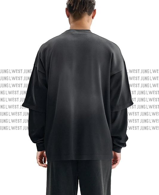 Person wearing a black oversized sweatshirt with text on the back