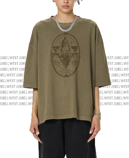 Person wearing a green t-shirt with a geometric design on a white background with 'JUNG WEST' branding.