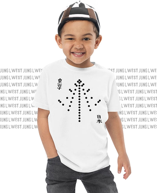 Child wearing a white t-shirt with black graphics and text, standing against a white background.